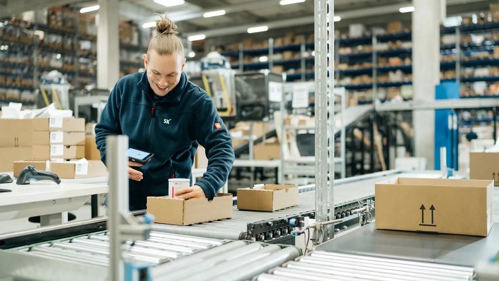 Logistics staff scanning and packaging generic pharmaceutical products
